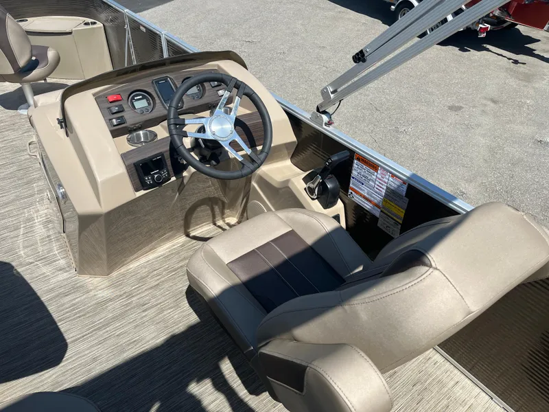 Slide: The Image of 2023 Bennington 22 SXFAPG boat helm with steering wheel and controls. - 12