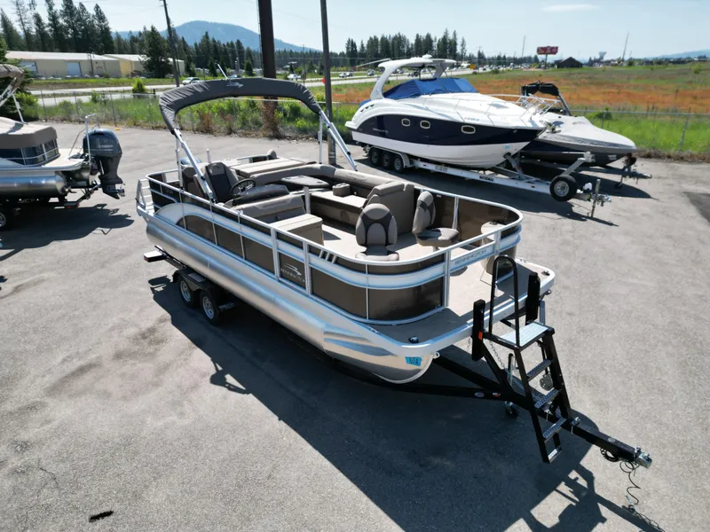 Slide: The Image of 2023 Bennington 22 SXFAPG pontoon boat on trailer in outdoor lot. - 3