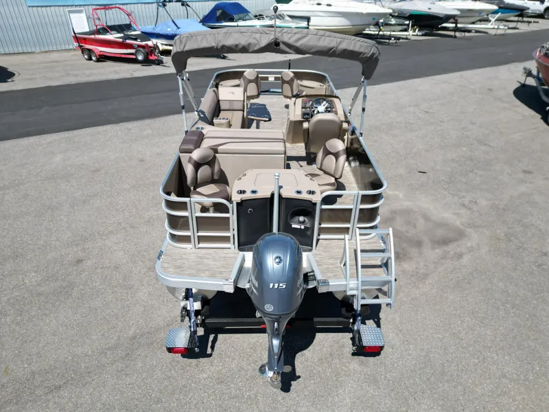 Slide: The Image of 2023 Bennington 22 SXFAPG pontoon boat with Yamaha 115 engine, docked at marina. - 6