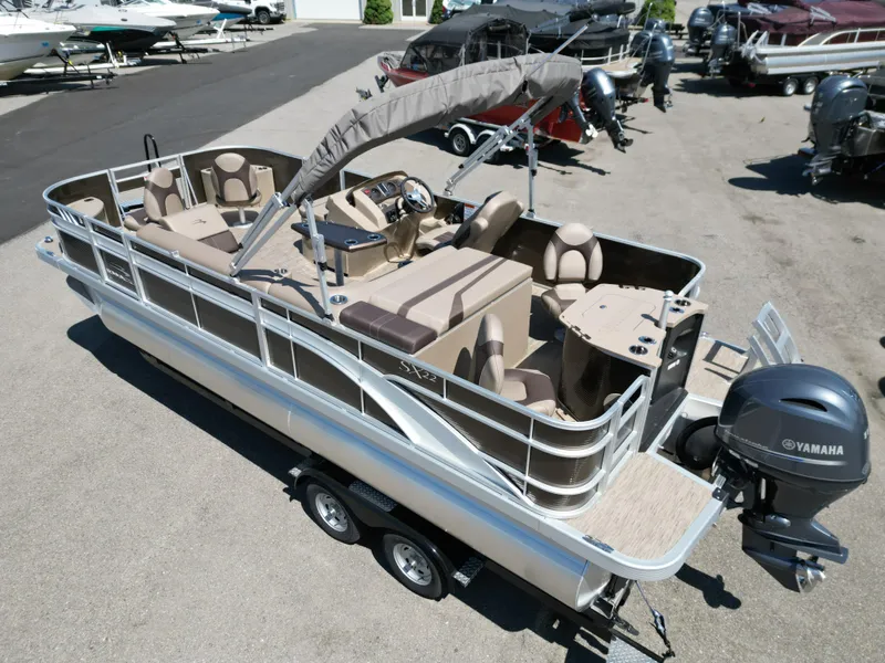 Slide: The Image of 2023 Bennington 22 SXFAPG pontoon boat with Yamaha motor, parked on a trailer. - 7