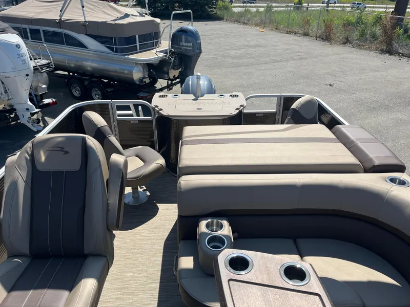Slide: The Image of 2023 Bennington 22 SXFAPG pontoon boat interior with seating and cup holders. - 9