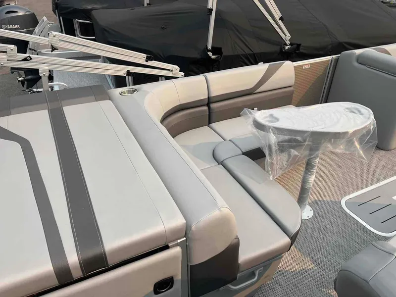 Slide: The Image of 2023 Bennington 22 SXSAPG pontoon boat with gray seating and table. - 14