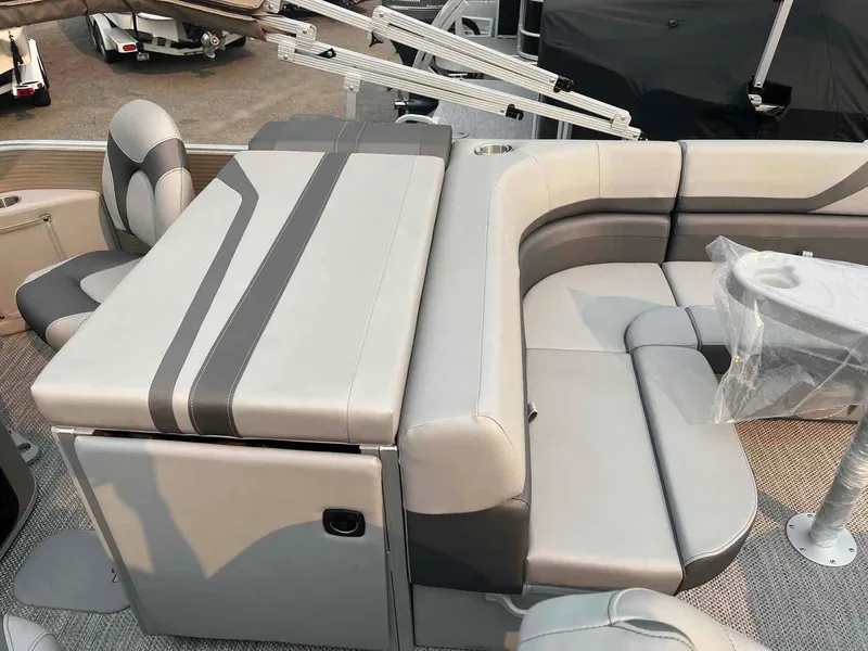 Slide: The Image of 2023 Bennington 22 SXSAPG pontoon boat interior with gray seating and table. - 15