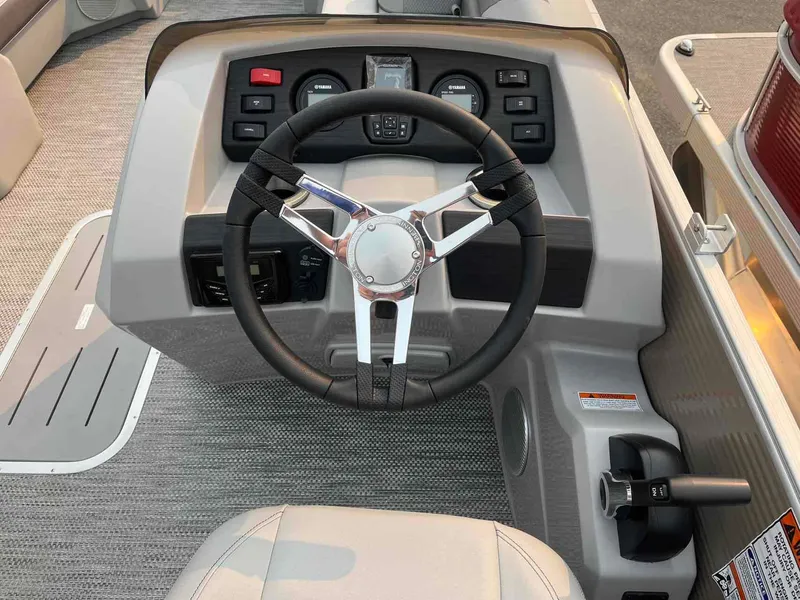 Slide: The Image of 2023 Bennington 22 SXSAPG boat steering console with modern controls and sleek design. - 17