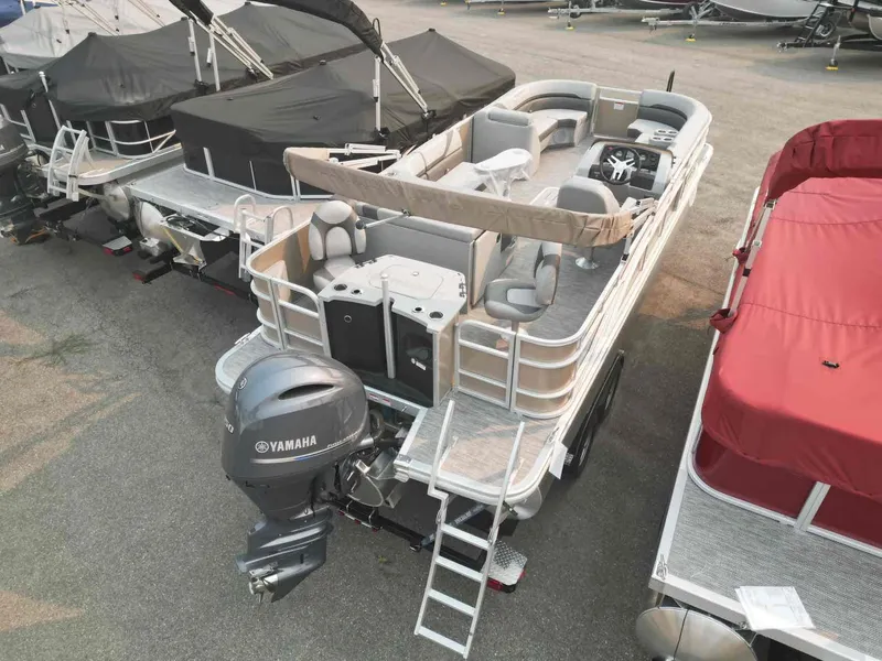 Slide: The Image of 2023 Bennington 22 SXSAPG pontoon boat with Yamaha motor, docked in marina. - 6