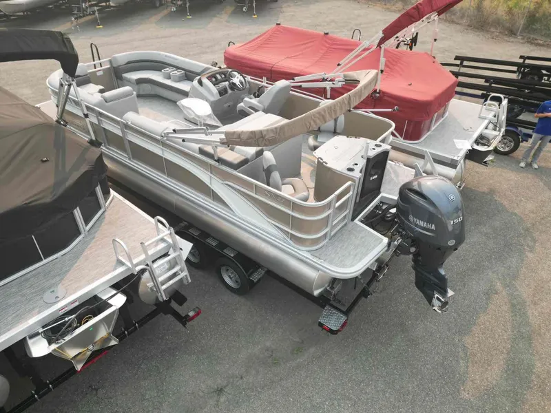 Slide: The Image of 2023 Bennington 22 SXSAPG pontoon boat with Yamaha engine, parked on a trailer. - 7