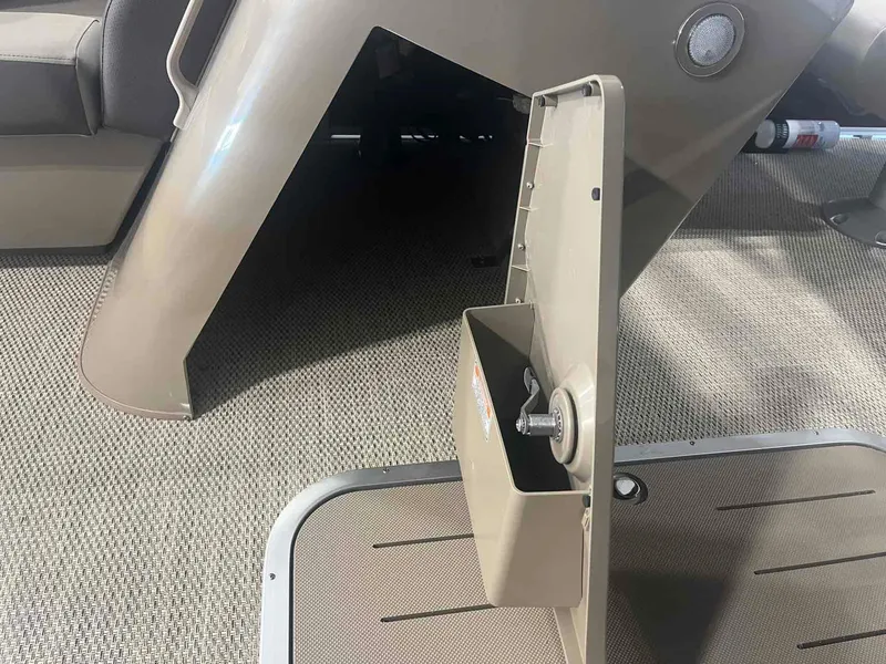 Slide: The Image of 2024 Bennington 22 SXSB boat interior with open storage compartment and carpeted flooring. - 10