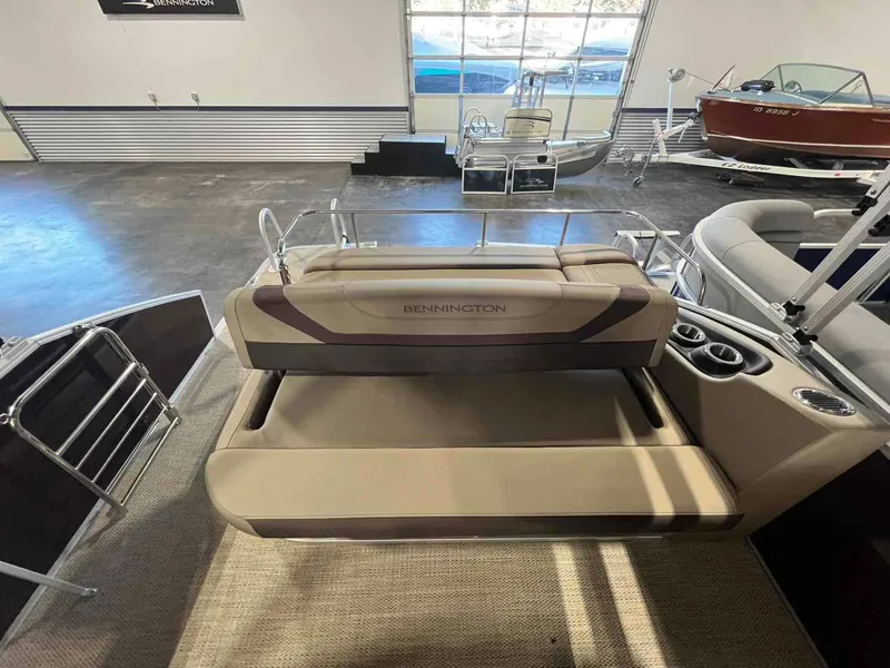 Slide: The Image of 2024 Bennington 22 SXSB pontoon boat interior with seating and cup holders. - 11