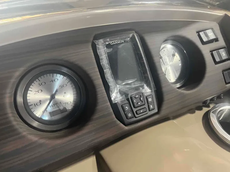 Slide: The Image of Dashboard of 2024 Bennington 22 SXSB with Garmin display and RPM gauge. - 14