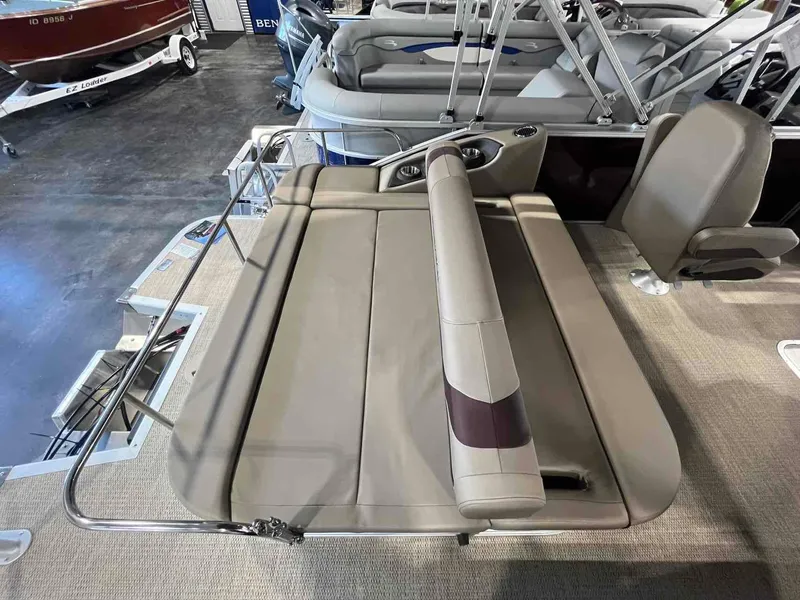 Slide: The Image of 2024 Bennington 22 SXSB boat interior with beige seating and metal railings. - 5