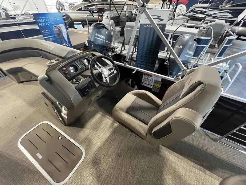 Slide: The Image of 2024 Bennington 22 SXSB boat interior with steering console and seating. - 8