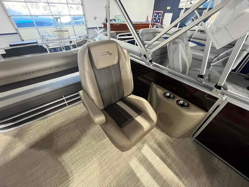 Slide: The Image of 2024 Bennington 22 SXSB boat interior with luxurious seating and cup holders. - 9