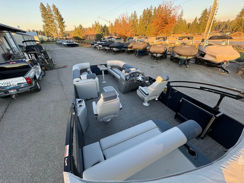Slide: The Image of 2024 Bennington 22SSB-SPS pontoon boat with spacious seating, parked outdoors. - 10