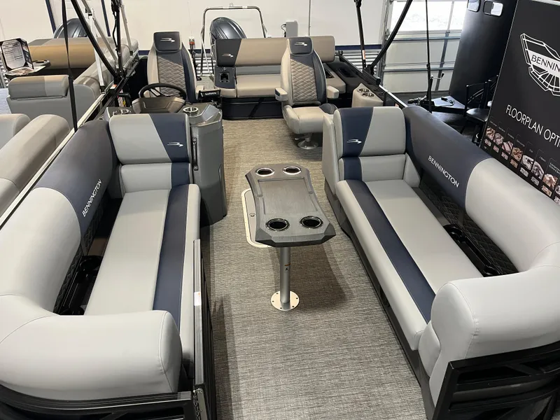 Slide: The Image of 2024 Bennington 22SSB-SPS pontoon boat interior with plush seating and table. - 12
