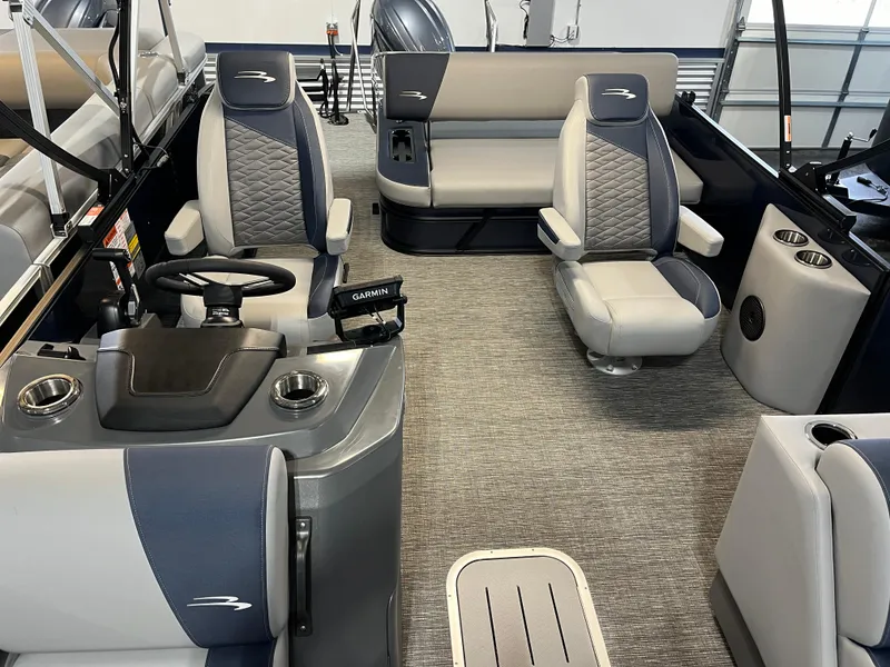 Slide: The Image of 2024 Bennington 22SSB-SPS pontoon boat interior with modern seating and steering console. - 13