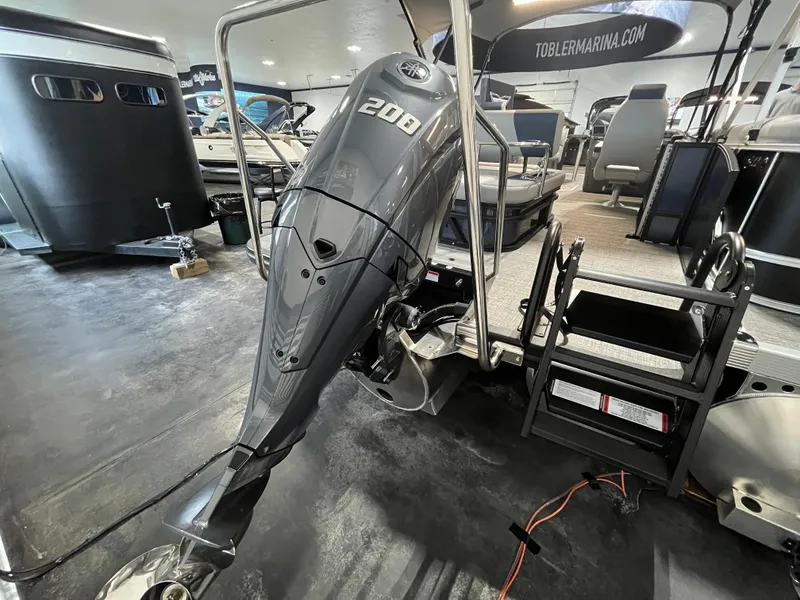 Slide: The Image of 2024 Bennington 22SSB-SPS pontoon boat with powerful 200HP outboard motor in showroom. - 15