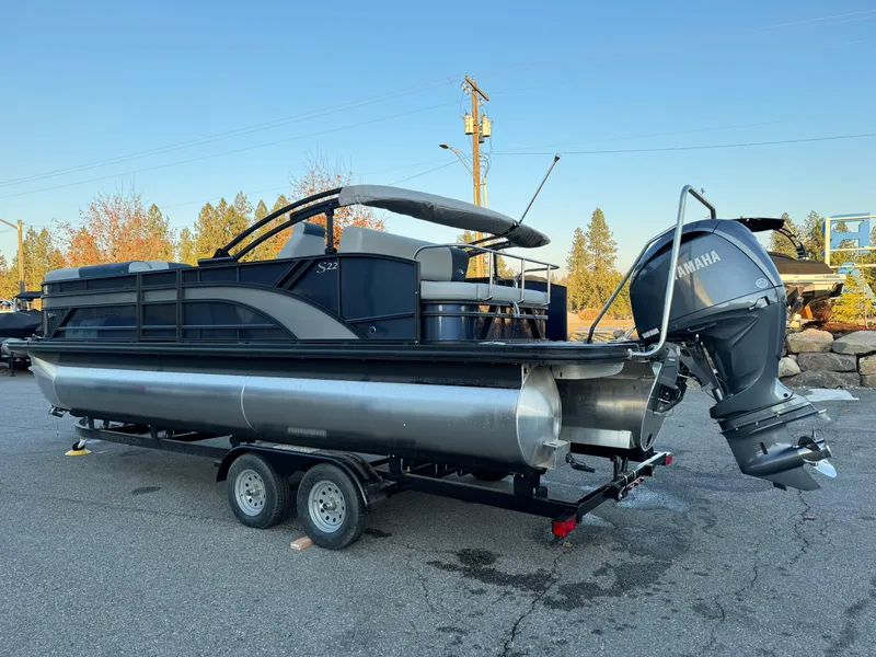Slide: The Image of 2024 Bennington 22SSB-SPS pontoon boat with Yamaha outboard motor on trailer. - 3