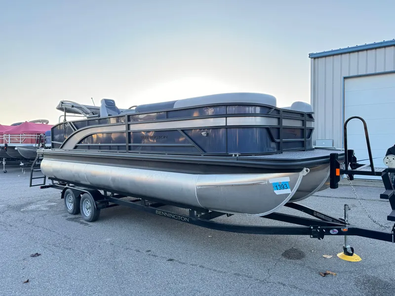 Slide: The Image of 2024 Bennington 22SSB-SPS pontoon boat on trailer, parked outdoors. - 4