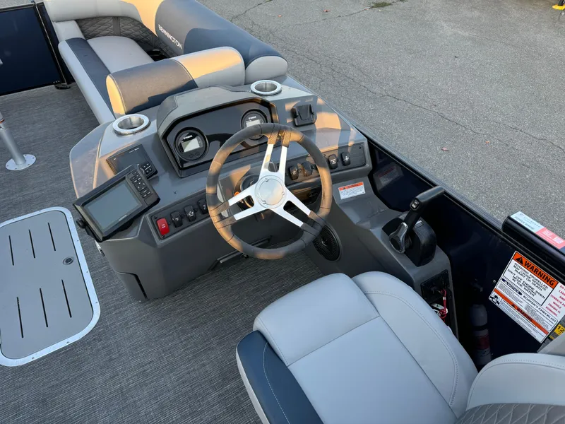 Slide: The Image of 2024 Bennington 22SSB-SPS boat dashboard with steering wheel and controls. - 6