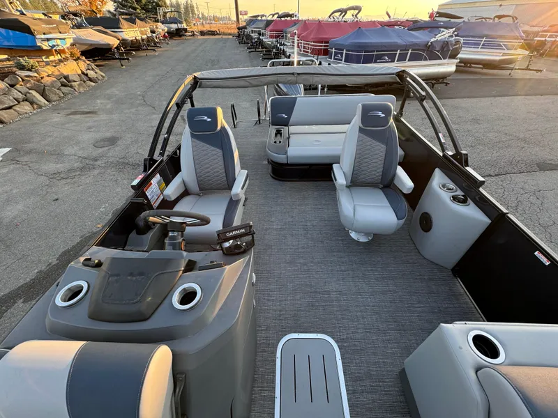 Slide: The Image of 2024 Bennington 22SSB-SPS pontoon boat interior with seating and steering console. - 7