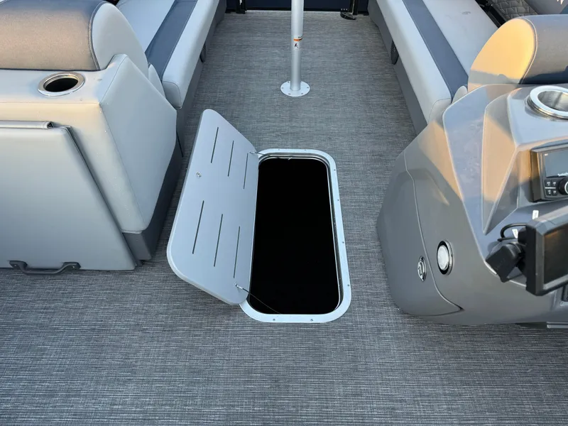 Slide: The Image of 2024 Bennington 22SSB-SPS pontoon boat interior with open storage compartment. - 8
