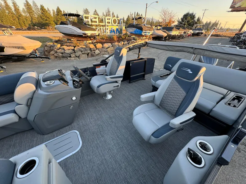 Slide: The Image of 2024 Bennington 22SSB-SPS pontoon boat interior with modern seating and steering console. - 9