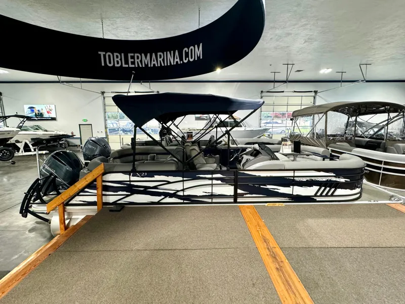 Slide: The Image of 2023 Bennington 23 LXFB pontoon boat displayed at Tobler Marina showroom. - 1