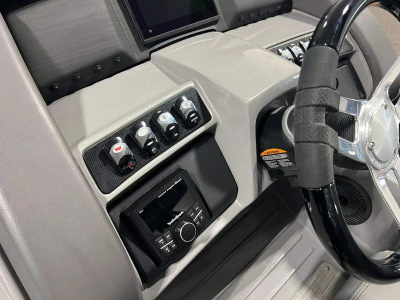 Slide: The Image of 2023 Bennington 23 LXFB boat dashboard with steering wheel and control panel. - 10