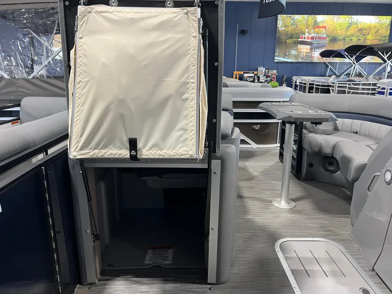 Slide: The Image of 2023 Bennington 23 LXFB boat interior with seating and table, showcasing modern design. - 13