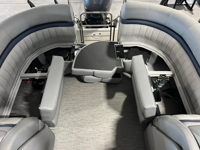 Slide: The Image of 2023 Bennington 23 LXFB boat interior with gray seating and central table. - 15