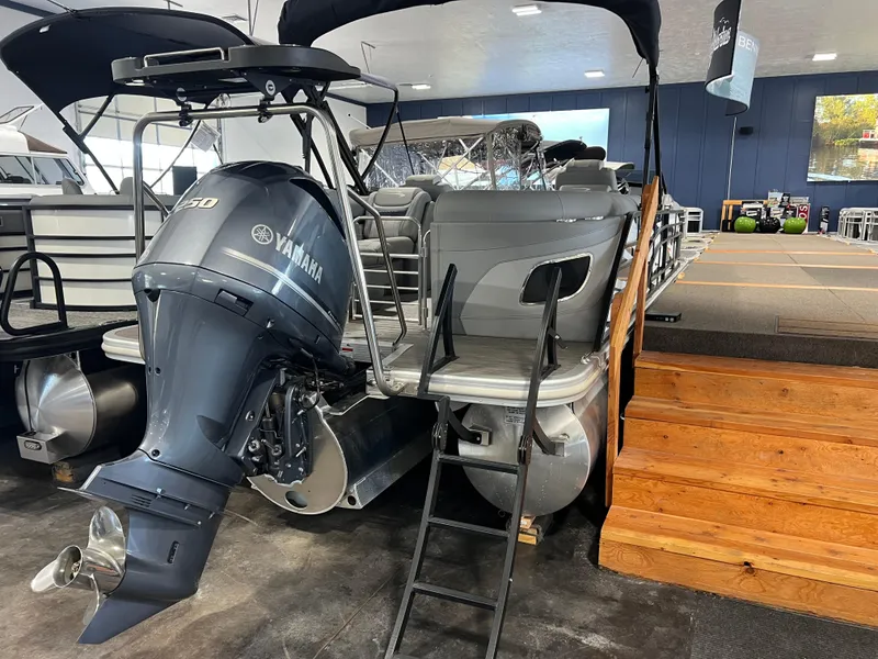 Slide: The Image of 2023 Bennington 23 LXFB pontoon boat with Yamaha outboard motor in showroom. - 16