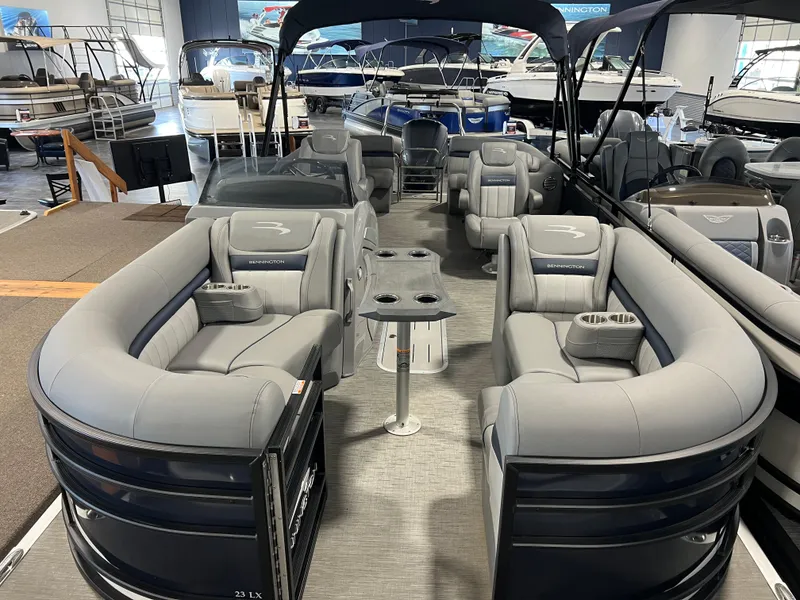 Slide: The Image of 2023 Bennington 23 LXFB pontoon boat with luxurious seating and modern design in showroom. - 3