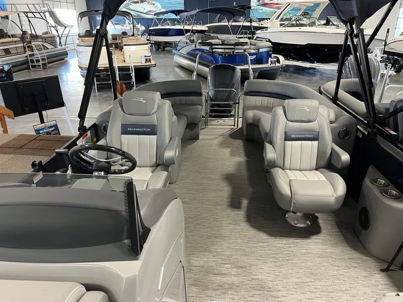 Slide: The Image of 2023 Bennington 23 LXFB pontoon boat interior with luxurious seating and steering console. - 5