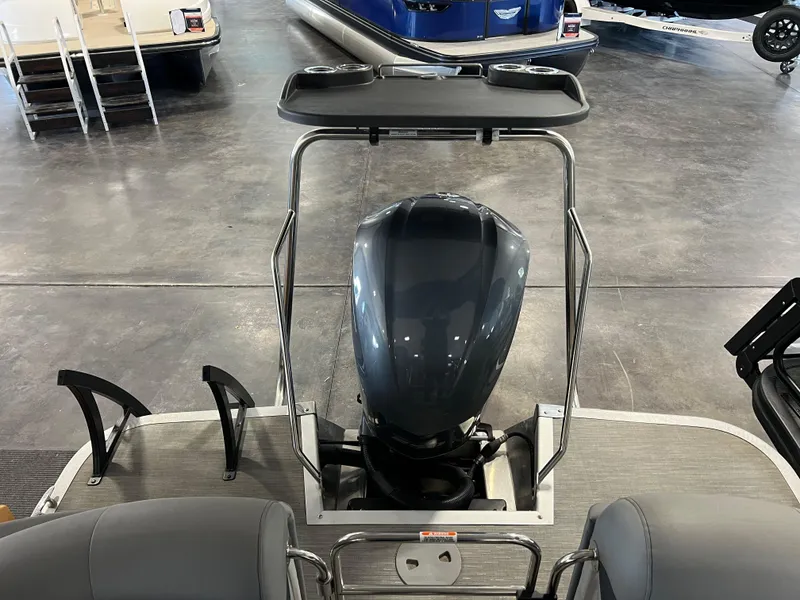 Slide: The Image of 2023 Bennington 23 LXFB boat interior with motor and seating. - 8