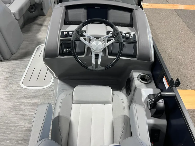 Slide: The Image of 2023 Bennington 23 LXFB boat helm with steering wheel and control panel. - 9