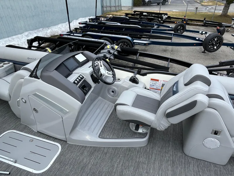 Slide: The Image of 2024 Bennington 24LXSFB boat interior with steering console and seating. - 12