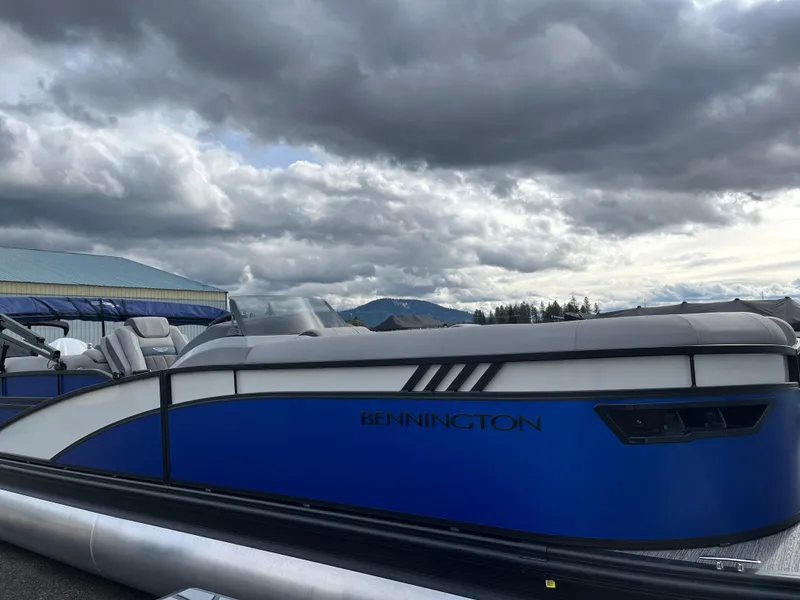 Slide: The Image of 2024 Bennington 24LXSFB pontoon boat under cloudy sky. - 5