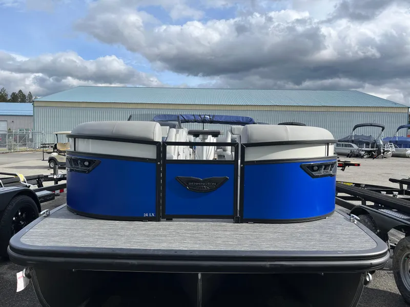 Slide: The Image of 2024 Bennington 24LXSFB pontoon boat with blue exterior, parked outdoors. - 6