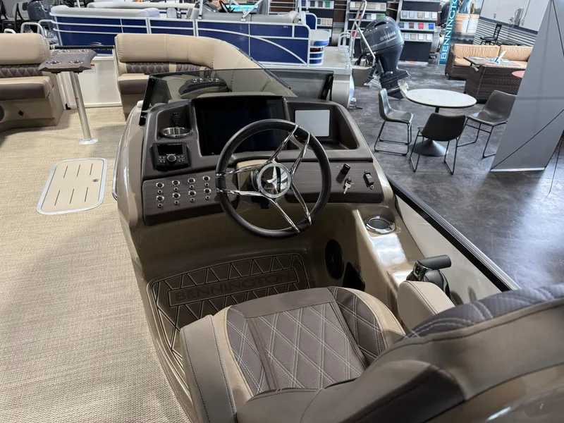 Slide: The Image of 2024 Bennington 28 QXFBAX1 boat interior with steering wheel and seating area. - 11