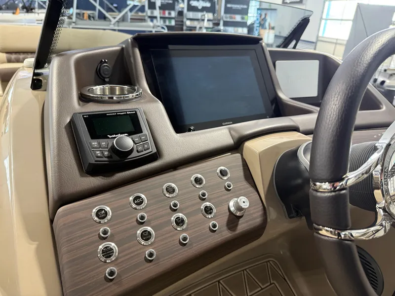 Slide: The Image of 2024 Bennington 28 QXFBAX1 boat dashboard with controls and touchscreen display. - 12