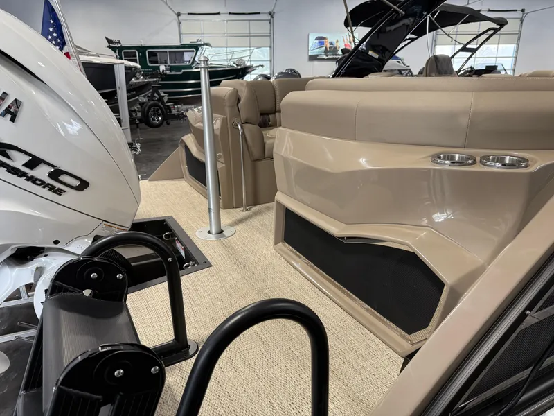 Slide: The Image of 2024 Bennington 28 QXFBAX1 boat interior with Yamaha motor, beige seating, and cup holders. - 16