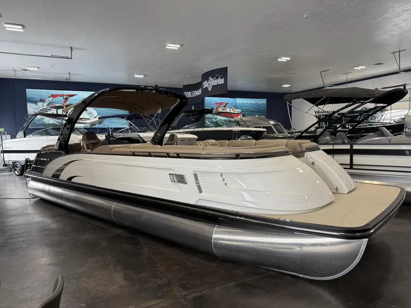 Slide: The Image of 2024 Bennington 28 QXFBAX1 pontoon boat displayed in a showroom. - 4