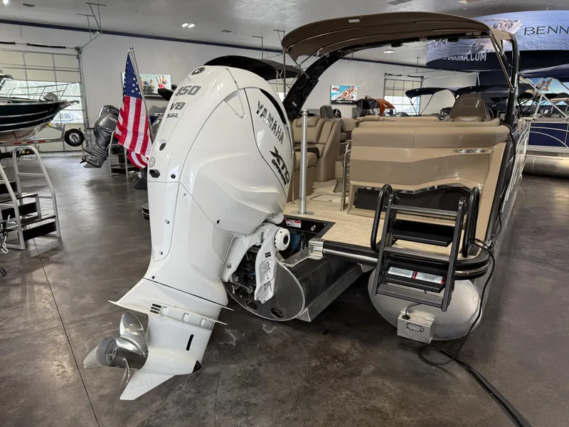 Slide: The Image of 2024 Bennington 28 QXFBAX1 pontoon boat with Yamaha V8 engine in showroom. - 6