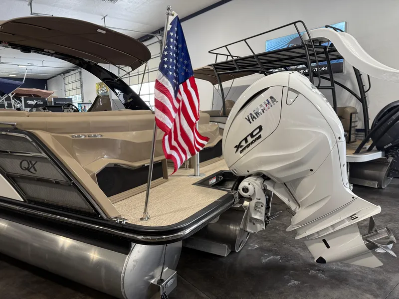Slide: The Image of 2024 Bennington 28 QXFBAX1 pontoon boat with Yamaha XTO engine and American flag. - 7
