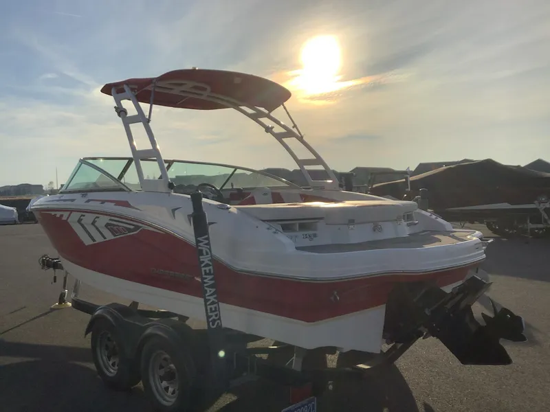 Slide: The Image of 2014 Chaparral 21 H2O boat at sunset, parked on a trailer. - 10
