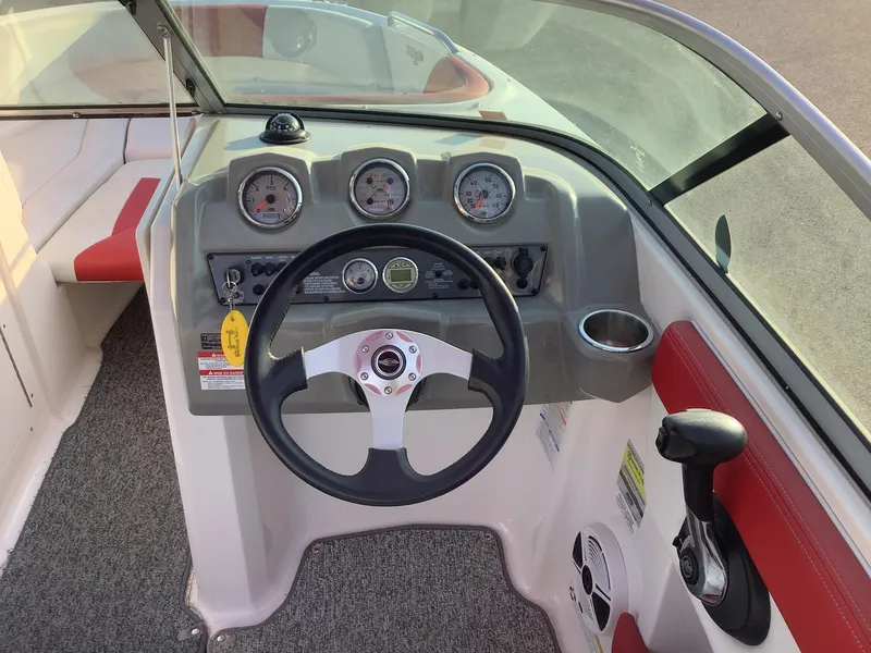 Slide: The Image of 2014 Chaparral 21 H2O boat dashboard with steering wheel and gauges. - 14