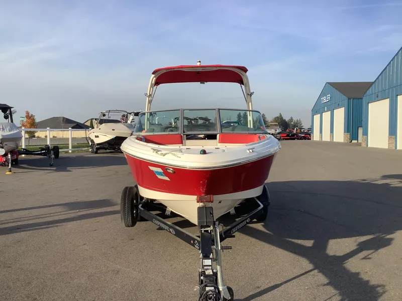 Slide: The Image of 2014 Chaparral 21 H2O boat on trailer, red and white, parked outdoors. - 3