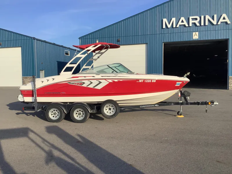 Slide: The Image of 2014 Chaparral 21 H2O boat in red, parked at a marina. - 7