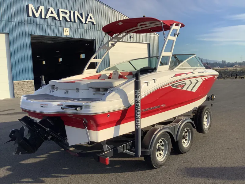 Slide: The Image of 2014 Chaparral 21 H2O boat in marina, red and white design, on trailer. - 8