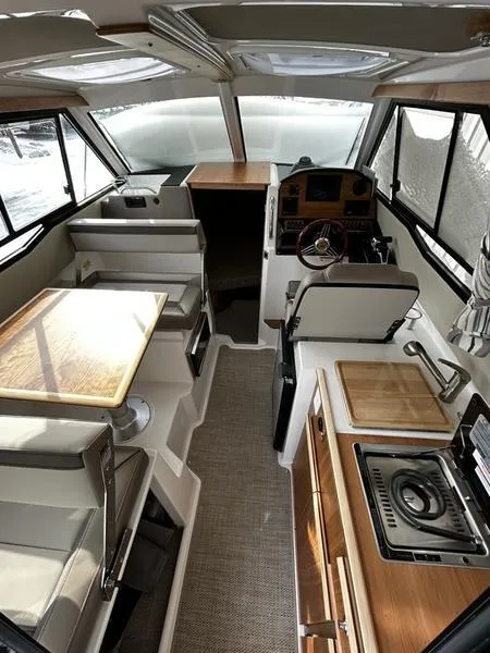 Slide: The Image of 2023 Cutwater C-248 C interior with modern kitchen and helm station. - 13